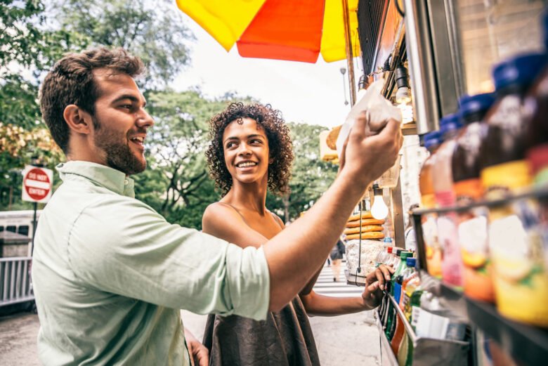 Couple shopping at a kiosk with business insurance in Bushwick, NY